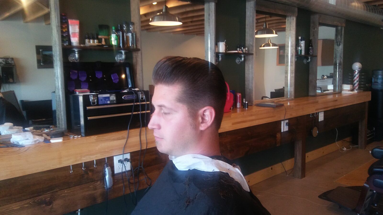 Pompadour haircut inside Quincy Barbers