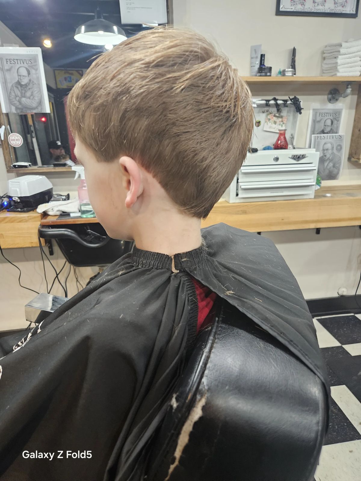 Textured quiff with mid fade at Quincy Barbers